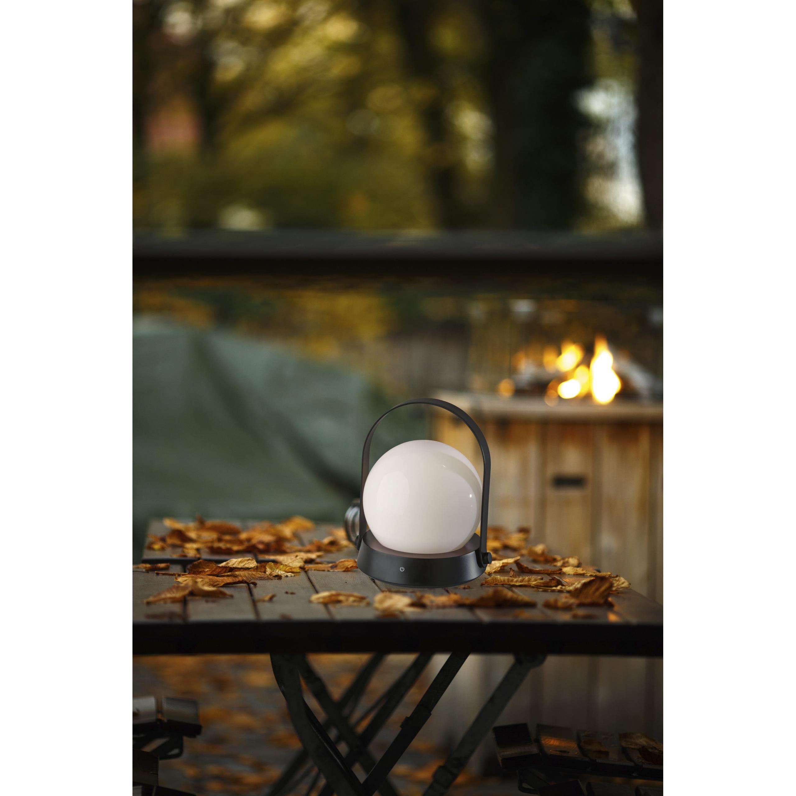 Millie LED Table Lantern on a table outside