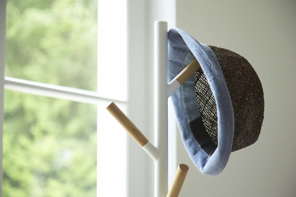 Plain Coat Rack with hat hung on it