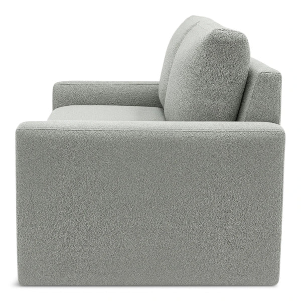 Side view of grey sofa on white background