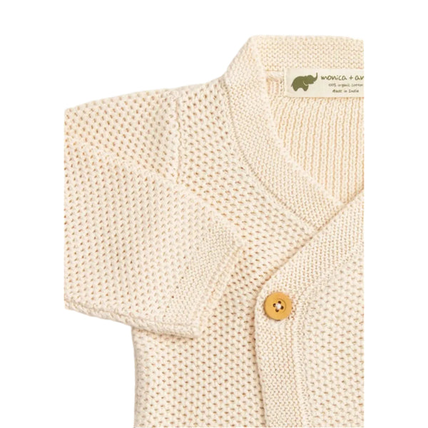 Cream Cardigan with Light Brown Button Detail on White Background